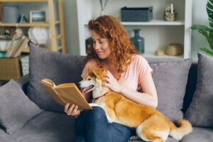 Pet sitter comforting a dog in its own home